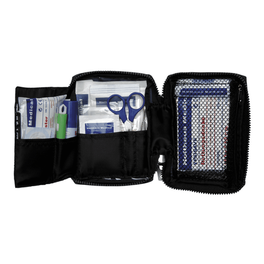 Eine Holthaus Medical Verbandtasche TRAVEL blau/rot mit Reißverschluss von Holthaus Medical GmbH & Co. KG liegt offen und zeigt verschiedene Erste-Hilfe-Artikel. Zu den Artikeln gehören Scheren, Pflaster, Alkoholtupfer, Mullkompressen und ein grüner Buntstift. Eine Netztasche auf der rechten Seite enthält zusätzliche Pflaster und eine Erste-Hilfe-Broschüre zum schnellen Nachschlagen.