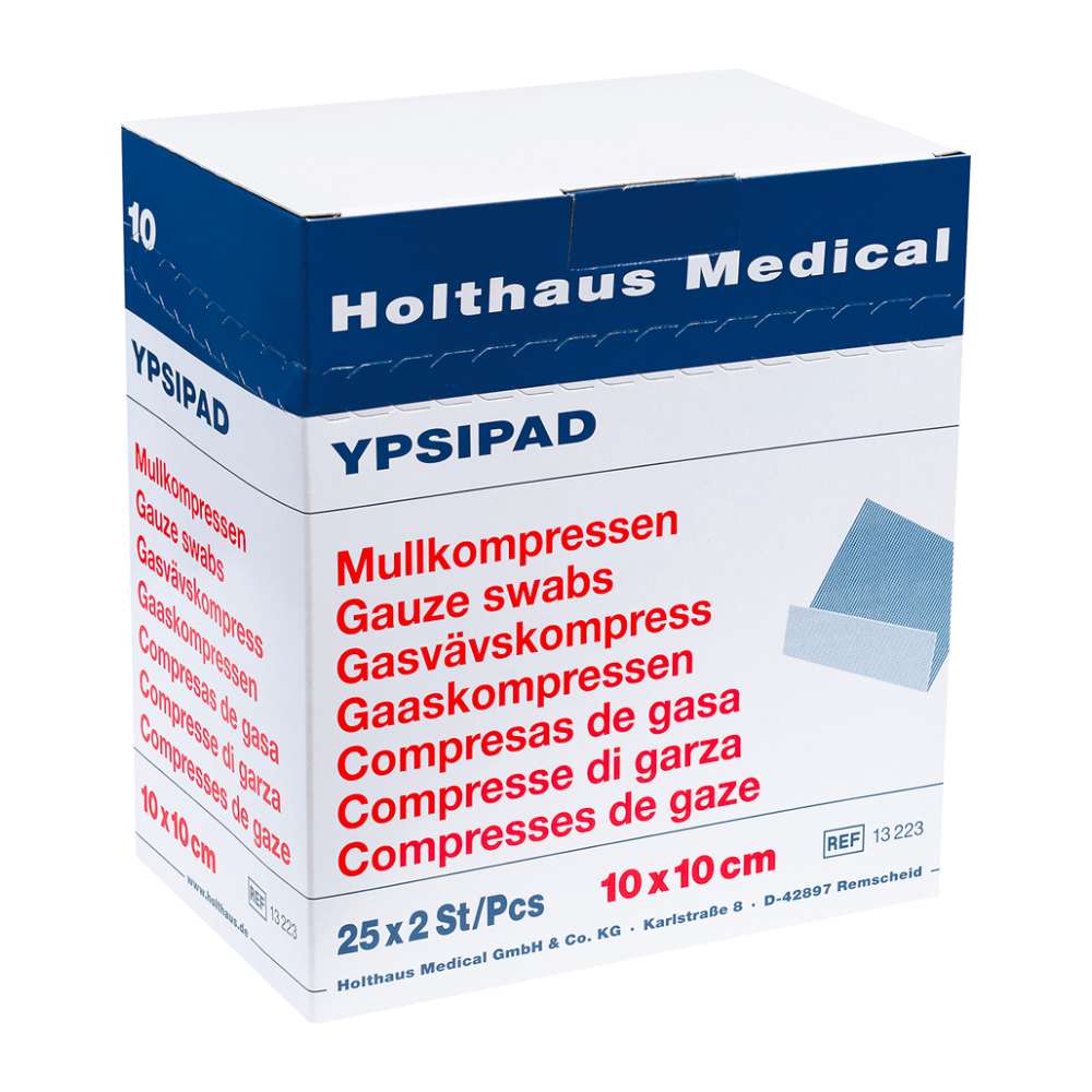 Ausgestellt ist eine Schachtel Holthaus YPSIPAD Mullkompresse der Holthaus Medical GmbH & Co. KG. Die sterile Verpackung enthält 25 Packungen mit je 2 Mulltupfern à 10x10 cm. Der Text ist mehrsprachig abgedruckt, darunter Deutsch, Englisch, Niederländisch und Spanisch.